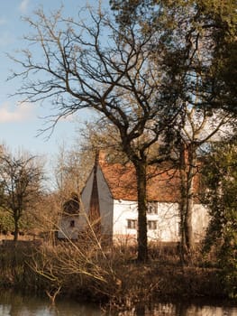 willy lotts cottage spring from across the lake on side river stour constable country close up  essex  england  uk
