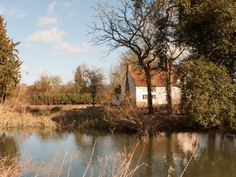 willy lotts cottage spring from across the lake on side river stour constable country  essex  england  uk