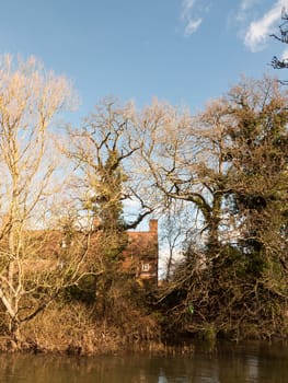 flatford mill house spring from across the lake on side river stour constable country close up  essex  england  uk