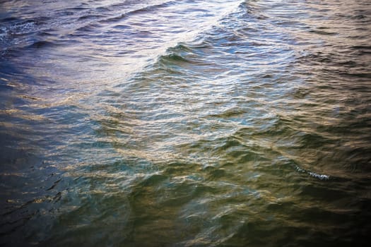 Sea waves background. Ocean water on a cloudy windy day. Top view.