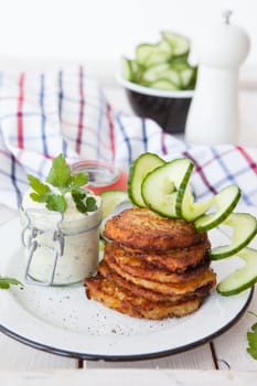 Fresh potato pancakes and cottage cheese with fresh herbs