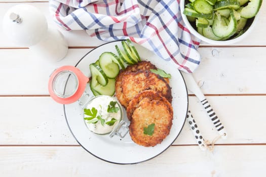 Fresh potato pancakes and cottage cheese with fresh herbs