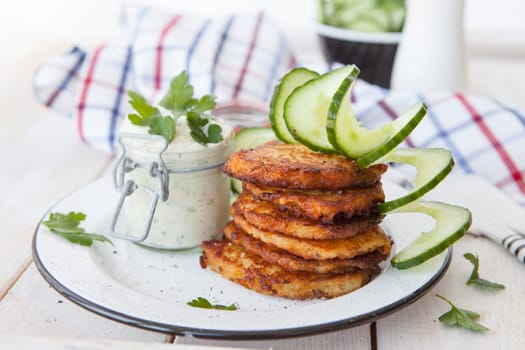 Fresh potato pancakes and cottage cheese with fresh herbs
