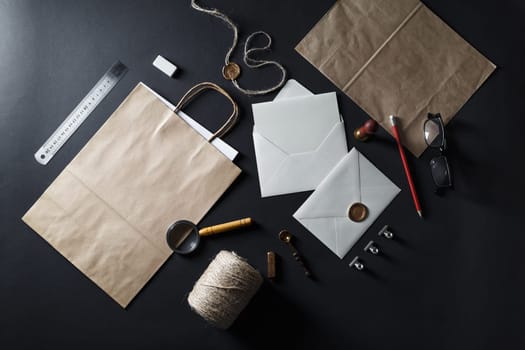 Blank vintage stationery elements on black paper background. Mock-up for your design. Flat lay.