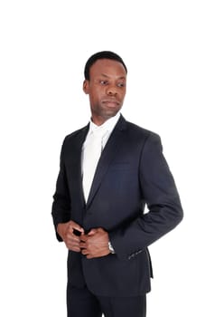 A young handsome African American business man standing in profile,.looking at the side, isolated for white background.
