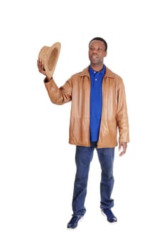 A good looking African American man lifting up his brown cowboy.hat, standing in a leather jacket, isolated for white background.