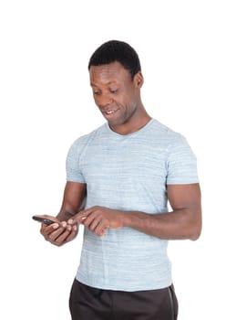 An handsome African American man standing in a gray t-shirt .looking at his cell phone and is puzzled, isolated for white background.