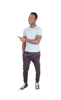 A smiling handsome African American man standing in truck pants.pointing with his finger and smiling, isolated for white background.
