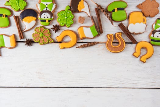 Gingerbreads for Patrick's day and on wooden background
