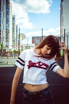portrait attractive women in sports white T-shirt Posing on football field