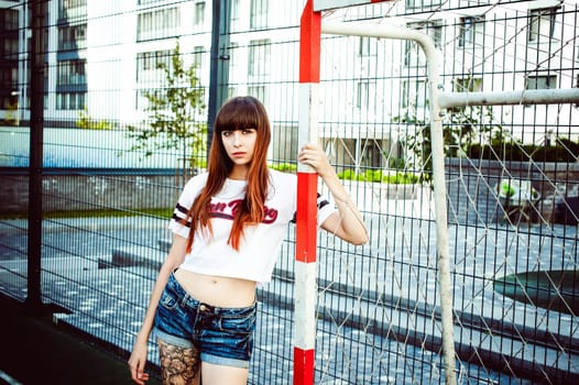 portrait attractive women in sports white T-shirt Posing on football field