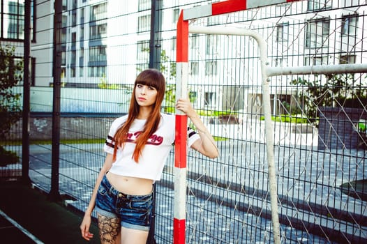 portrait attractive women in sports white T-shirt Posing on football field