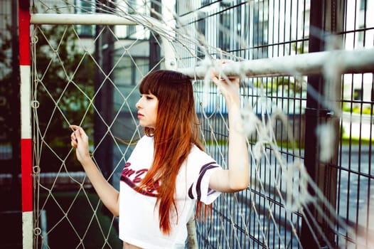 portrait attractive women in sports white T-shirt Posing on football field