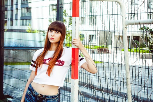 portrait attractive women in sports white T-shirt Posing on football field
