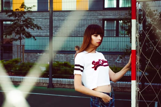 portrait attractive women in sports white T-shirt Posing on football field