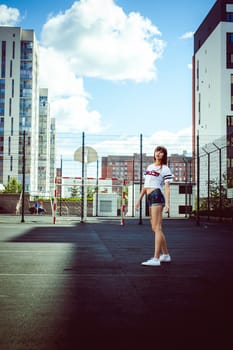 portrait attractive women in sports white T-shirt Posing on football field