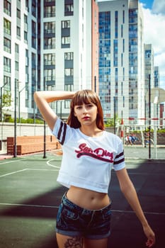 portrait attractive women in sports white T-shirt Posing on football field