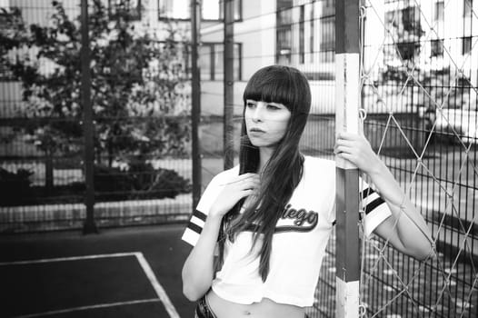 portrait attractive women in sports white T-shirt Posing on football field