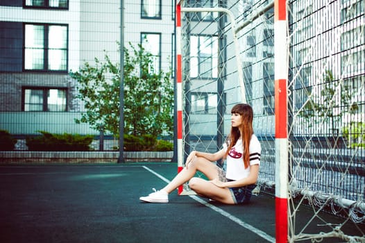 portrait attractive women in sports white T-shirt Posing on football field