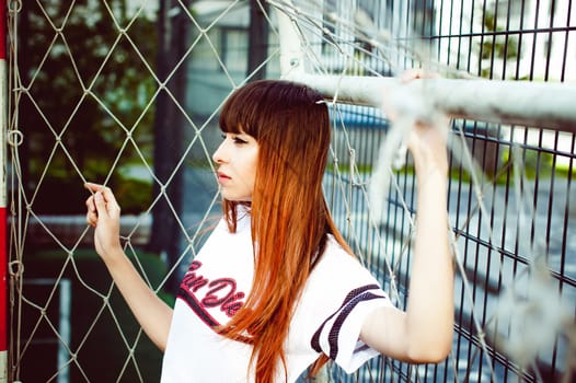 portrait attractive women in sports white T-shirt Posing on football field