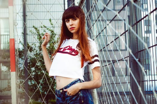portrait attractive women in sports white T-shirt Posing on football field