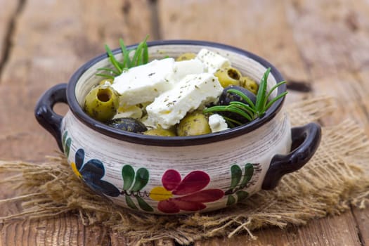 feta cheese and olives with herbs in olive oil