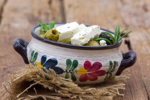 feta cheese and olives with herbs in olive oil