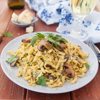 Taglietelle noodles with mushrooms and cream vinegar