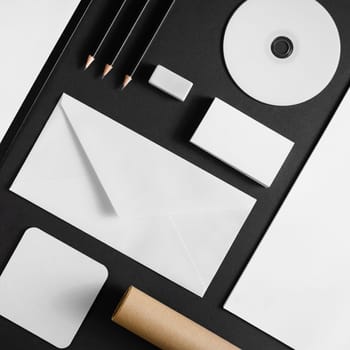 Photo of blank stationery set on black paper background. Corporate ID mock up for placing your design. Flat lay.