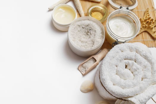 Spa and wellness cosmetic products on white paper background. Space for text.