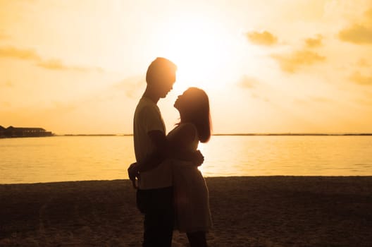 Loving couple on the beach. Couple in love.  Maldives vacation. Lifestyle. Travel, vacation, love, romance, sunset.
