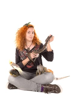 Girl with several pet animals isolated in white