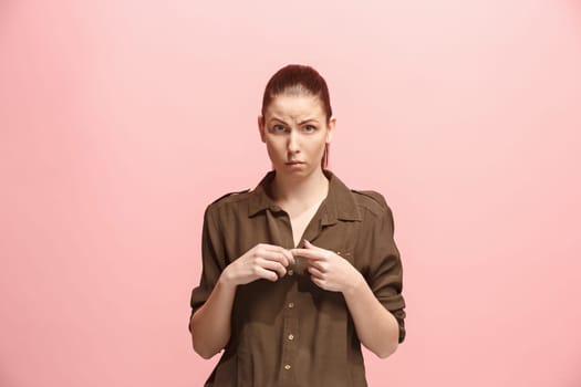 Why is that. Beautiful female half-length portrait isolated on trendy pink studio backgroud. Young emotional surprised, frustrated and bewildered woman. Human emotions, facial expression concept.