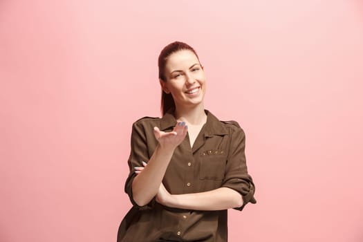 Happy business woman standing and smiling isolated on pink studio background. Beautiful female half-length portrait. Young emotional woman. The human emotions, facial expression concept. Front view.