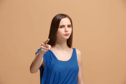 I choose you and order. Overbearing woman point you, want you, half length closeup portrait on pastel studio background. The human emotions, facial expression concept. Front view. Trendy colors