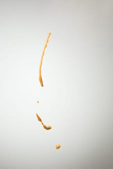 The splash of mustard on gray background
