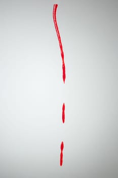 The splash of ketchup isolated on gray studio background