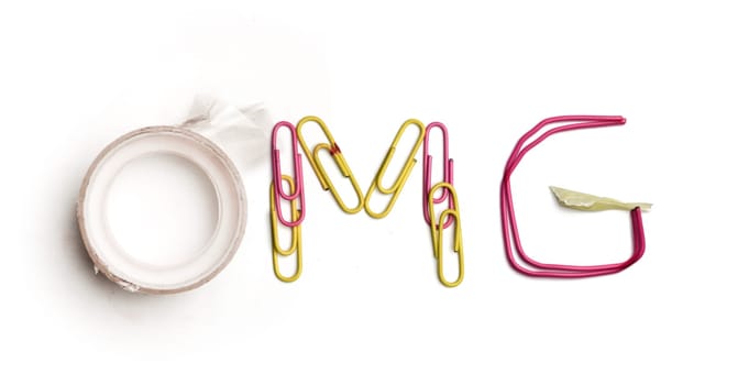 Concept of idea with colorful crumpled paper. The word Omg created from office stationery. The art, creative, letters concepts. Conceptual image. Top view, isolated on white desk. Work tool concept
