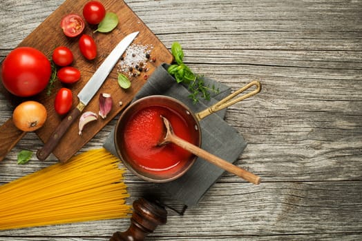 Fresh ingredients for cooking pasta on wooden background place for text. Vegan food vegetarian and healthy cooking concept.