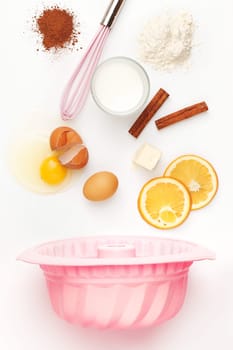 The falling ingredients of pie or cake on white table background