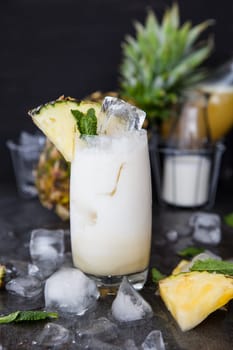 Tall glass with Pina Colada cocktail on ice