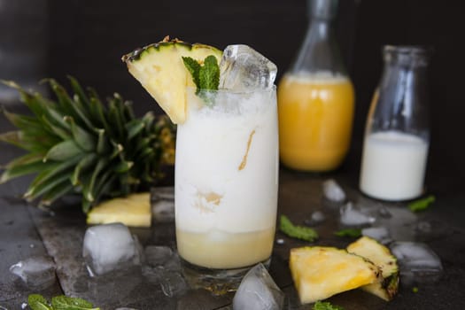 Tall glass with Pina Colada cocktail on ice