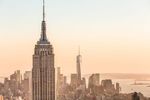 New York City. Manhattan downtown skyline with illuminated Empire State Building and skyscrapers at sunset. USA.