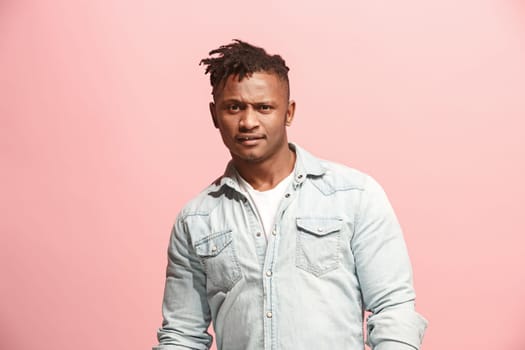 Delight. African american male half-length front portrait isolated on pink studio backgroud. Young, emotional, smiling, surprised man standing. Human emotions, facial expression concept. Trendy colors
