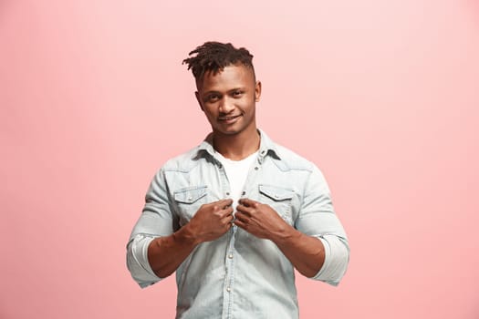 Happy business man standing and smiling isolated on pink studio background. Beautiful male half-length portrait. Young emotional man. The human emotions, facial expression concept. Front view.