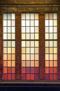 Old colored windows with warm shades. Red, orange, yellow squares.