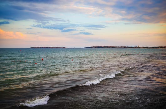 Sea surf at dawn. Morning seascape. Picturesque sky and waves. Black sea coast.