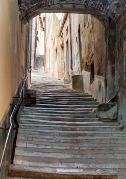 ancient staircase with an arch in the center of Cortona in Tuscany, Italy