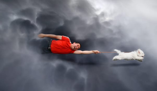 Dog running and dragging a man by the leash through the clouds. Canine education.