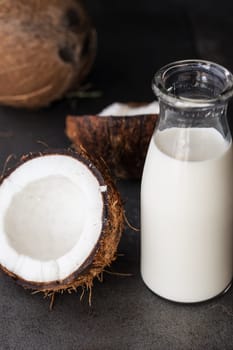 Small bottle of coconut milk and fresh coconut